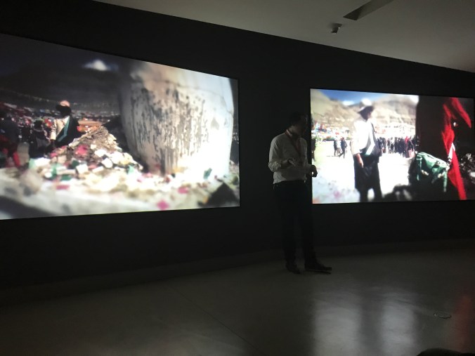 Suddenly Mad- The Moral of the Story - Jeremy docent in front of film projection with offerings of incense