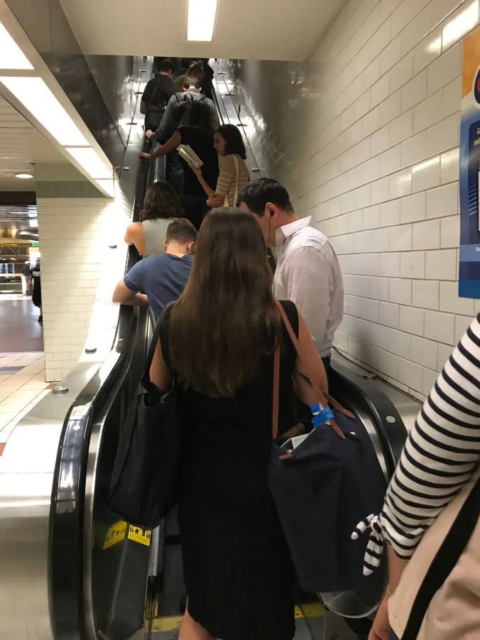 Suddenly Mad- Port Authority escalator with people waiting for the bus